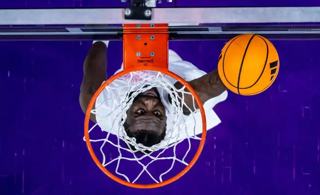 Washington Huskies center Franck Kepnang dunks during warmups before an NCAA college basketball game against the Iowa Hawkeyes, Wednesday, Feb. 4, 2026, in Seattle. (AP Photo/Maddy Grassy)