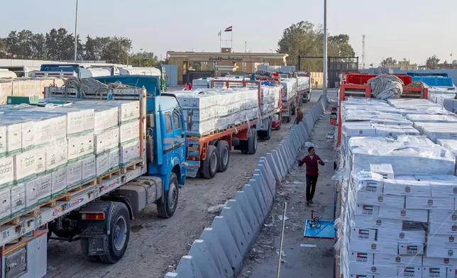 Trucks carrying humanitarian aids line up to enter the Egyptian gate of the Rafah crossing, heading for inspection by Israeli authorities before entering the Gaza Strip, in Rafah, Egypt, Sunday, Feb. 1, 2026. (AP Photo/Mohamed Arafat)