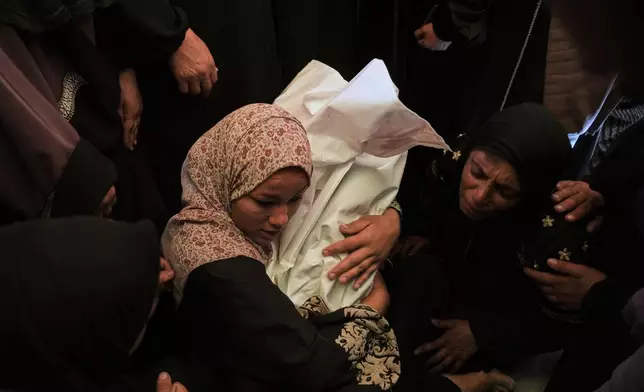 Khadija Abu Rabi cradles the body of her son, Iyad, 3, who was killed when an Israeli strike hit tents sheltering displaced people along the coast of Khan Younis, according to hospital officials, at Nasser Hospital in Khan Younis, Gaza Strip, Monday, Feb. 2, 2026. (AP Photo/Jehad Alshrafi)