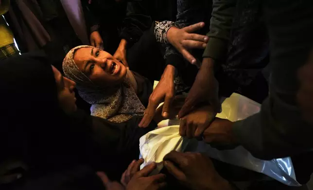 Khadija Abu Rabi mourns over the body of her son, Iyad, 3, who was killed when an Israeli strike hit tents sheltering displaced people along the coast of Khan Younis, according to hospital officials, at Nasser Hospital in Khan Younis, Gaza Strip, Monday, Feb. 2, 2026. (AP Photo/Jehad Alshrafi)