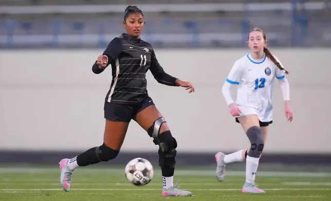 Plano East varsity soccer player Aliya Jacob, left, controls the ball against Rock Hill's Hanna Schinner during a soccer game, Jan. 30, 2026, in Murphy, Texas. (AP Photo/Julio Cortez)