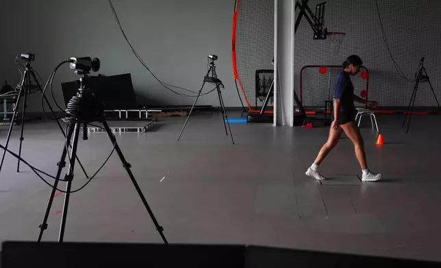 Cameras analyze Plano East High School soccer player Sofia Tepichian, right, as she walks at the Movement Science Laboratory at Scottish Rite for Children in Frisco, Texas, Jan. 22, 2026. (AP Photo/LM Otero)