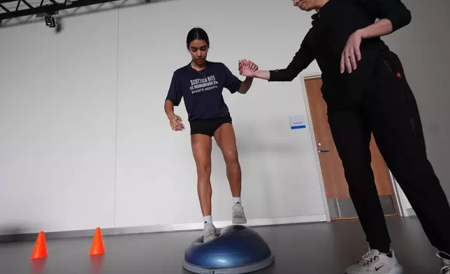 Plano East High School soccer player Sofia Tepichian, left, is helped by sports biomechanics researcher Sophia Ulman at the Movement Science Laboratory at Scottish Rite for Children in Frisco, Texas, Jan. 22, 2026. (AP Photo/LM Otero)