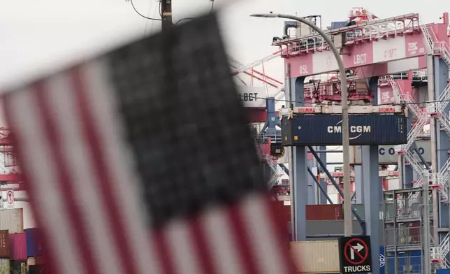 A U.S. flag files at the Port of Long Beach Friday, Feb. 20, 2026, in Long Beach, Calif. (AP Photo/Damian Dovarganes)