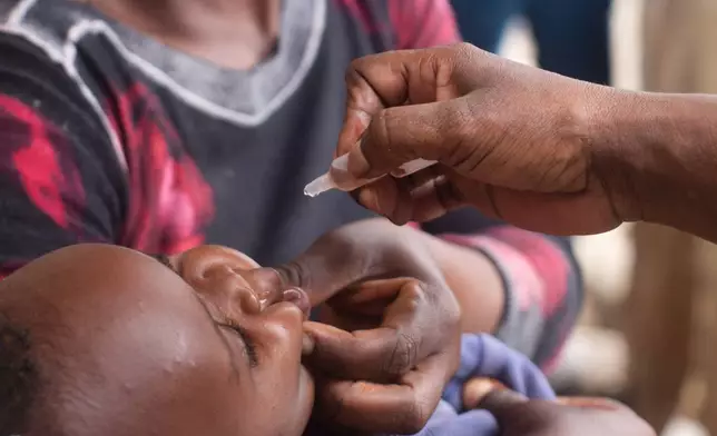 A healthcare worker administers polio vaccine to a child in the Ndirande Township of Blantyre, Malawi, Wednesday, Feb. 11, 2026. (AP Photo/Kenneth Jali)