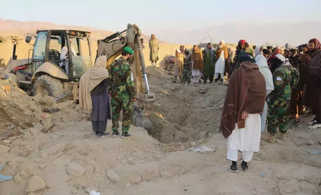 A bulldozer clears the rubble of a house hit by a cross-border Pakistani army strike in the Behsud district of Nangarhar province, Afghanistan, Sunday, Feb. 22, 2026. (AP Photo/Hedayat Shah)