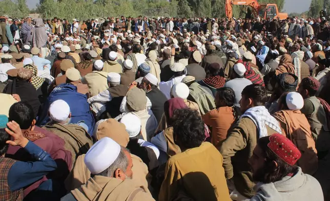 People attend the funeral of victims of a series of cross-border Pakistani army strikes that Pakistan said targeted hideouts of militants it blames for recent attacks inside the country, in the Behsud district of Nangarhar province, Afghanistan, Sunday, Feb. 22, 2026. (AP Photo/Wahidullah Kakar)