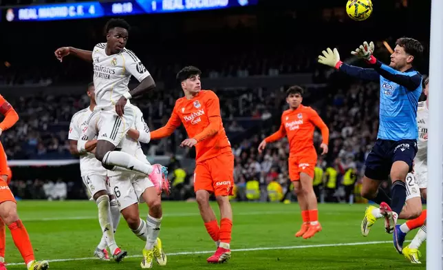 Real Madrid's Vinicius Junior, top left, scores a goal that was disallowed by the VAR during the Spanish La Liga soccer match between Real Madrid and Real Sociedad in Madrid, Spain, Saturday, Feb. 14, 2026. (AP Photo/Manu Fernandez)