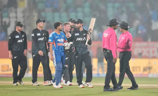 New Zealand's Devon Conway talks to India's Kuldeep Yadav as they leave the field after New Zealand won fourth T20 cricket match against India in Visakhapatnam, India, Wednesday, Jan. 28, 2026. (AP Photo/Aijaz Rahi)