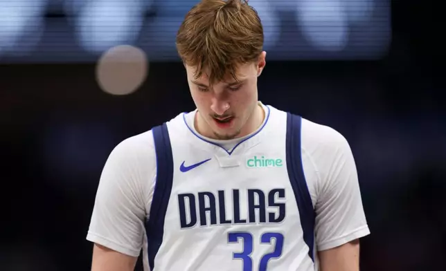 Dallas Mavericks forward Cooper Flagg (32) walks off the court in the first half of an NBA basketball game against the San Antonio Spurs, Thursday, Feb. 5, 2026, in Dallas. (AP Photo/Gareth Patterson)