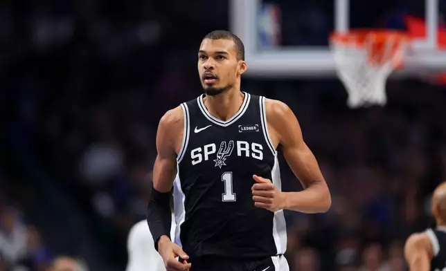 San Antonio Spurs forward Victor Wembanyama (1) runs the court in the first half of an NBA basketball game against the Dallas Mavericks, Thursday, Feb. 5, 2026, in Dallas. (AP Photo/Gareth Patterson)