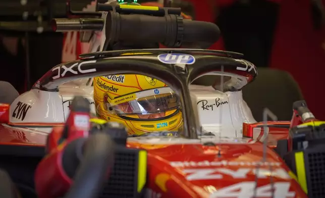 Ferrari driver Lewis Hamilton of Britain waits in his car on the third day of Formula One pre-season test at the Bahrain International Circuit in Sakhir, Bahrain, Friday, Feb. 13, 2026. (AP Photo/Altaf Qadri)