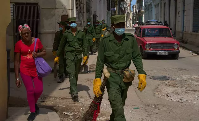 Soldiers walk through Old Havana to collect garbage in Havana, Cuba, Thursday, Feb. 26, 2026. (AP Photo/Ramon Espinosa)