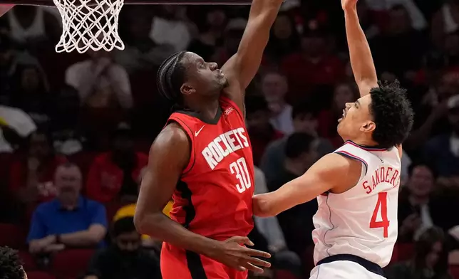 Houston Rockets center Clint Capela (30) blocks a shot by Los Angeles Clippers guard Kobe Sanders (4) during the first half of an NBA basketball game, Tuesday, Feb. 10, 2026, in Houston. (AP Photo/ Karen Warren)