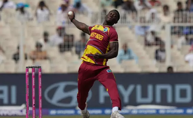 West Indies' Shamar Joseph bowls a delivery during the T20 World Cup cricket match between West Indies and Italy in Kolkata, India, Thursday, Feb. 19, 2026. (AP Photo/Bikas Das)