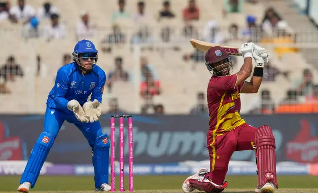 West Indies' captain Shai Hope hits a six during the T20 World Cup cricket match between West Indies and Italy in Kolkata, India, Thursday, Feb. 19, 2026. (AP Photo/Bikas Das)