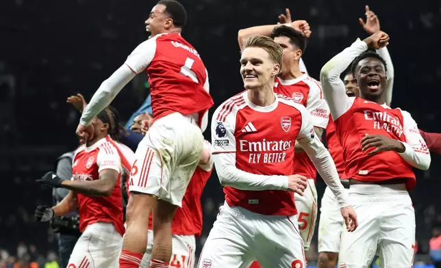 Arsenal players celebrate winning the English Premier League soccer match between Tottenham Hotspur and Arsenal in London, Sunday, Feb. 22, 2026.(AP Photo/Ian Walton)