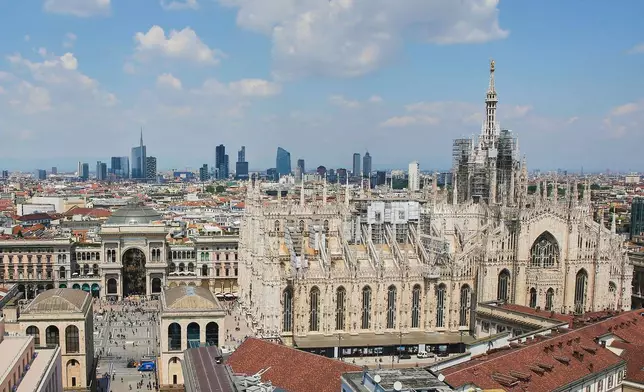 FILE - This photo shows Milan's CityLife district, including the city's tallest buildings, towering over historic architecture such as the Duomo cathedral at right, on Oct. 25, 2017. (AP Photo/Luca Bruno, File)