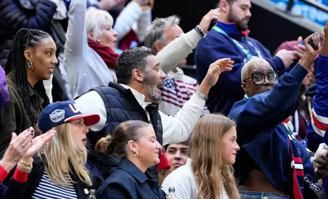 Family members of United States' Laila Edwards cheer during a women's ice hockey semifinal game between the United States and Sweden at the 2026 Winter Olympics, in Milan, Italy, Monday, Feb. 16, 2026. (AP Photo/Hassan Ammar)