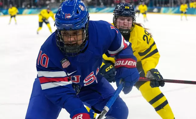 United States' Laila Edwards (10) challenges with Sweden's Felizia Wikner Zienkiewicz (29) during a women's ice hockey semifinal game between the United States and Sweden at the 2026 Winter Olympics, in Milan, Italy, Monday, Feb. 16, 2026. (AP Photo/Hassan Ammar)