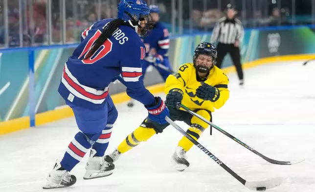 United States' Laila Edwards (10) challenges with Sweden's Hilda Svensson (8) during a women's ice hockey semifinal game between the United States and Sweden at the 2026 Winter Olympics, in Milan, Italy, Monday, Feb. 16, 2026. (AP Photo/Hassan Ammar)