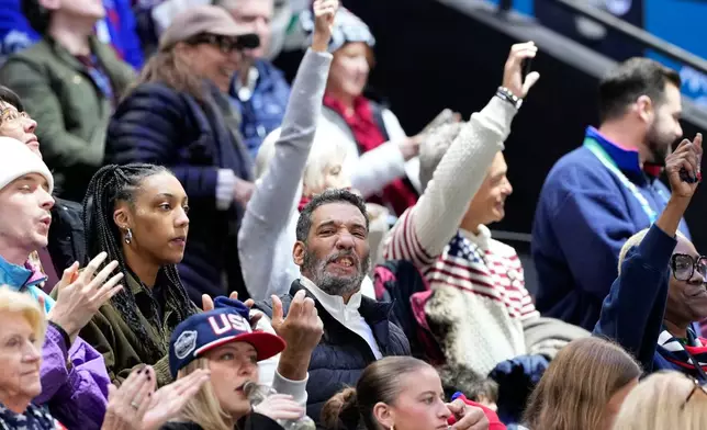 Robert Edwards, center, the father of United States' Laila Edwards cheers during a women's ice hockey semifinal game between the United States and Sweden at the 2026 Winter Olympics, in Milan, Italy, Monday, Feb. 16, 2026. (AP Photo/Hassan Ammar)