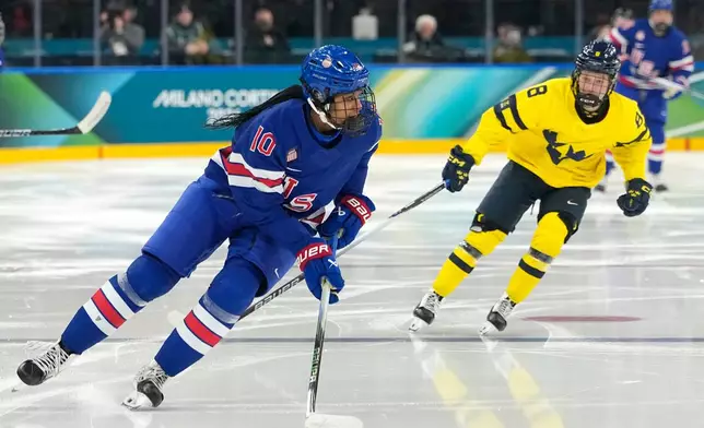 United States' Laila Edwards (10) is challenged by Sweden's Hilda Svensson (8) during a women's ice hockey semifinal game between the United States and Sweden at the 2026 Winter Olympics, in Milan, Italy, Monday, Feb. 16, 2026. (AP Photo/Hassan Ammar)