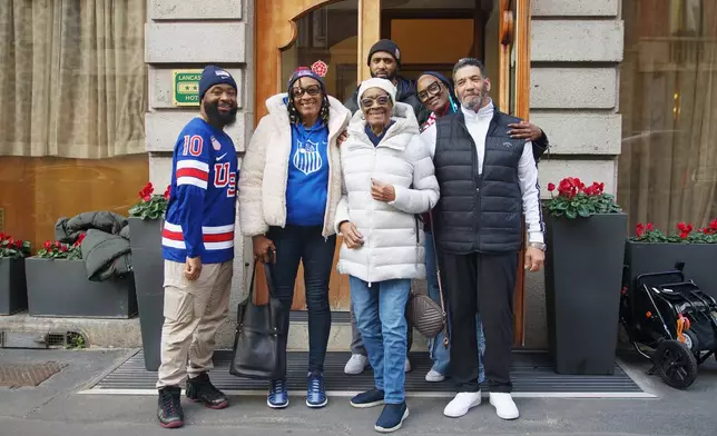 Laila Edwards’ family pose for a photo in front of their hotel from left, Terrell Duckworth, cousin; Vanessa Duckworth, aunt; Ernestine Gray, grandmother; Charone Gray-Edwards, mother; Robert Edwards, father; background, Bobby Edwards, 27, Laila’s brother, at the 2026 Winter Olympics, in Milan, Italy, Monday, Feb. 16, 2026. (AP Photo/Annie Risemberg)