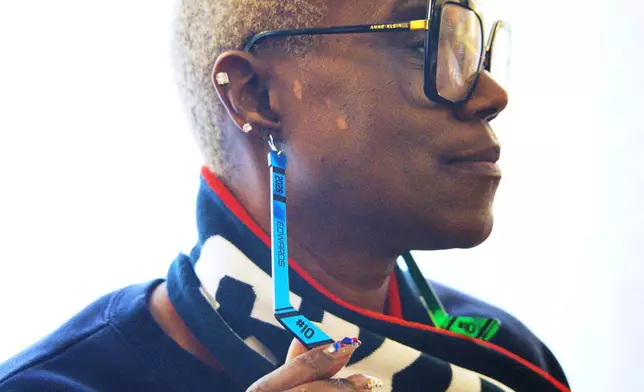 Charone Gray-Edwards, Laila Edwards’ mother, displays hockey stick earrings with Laila’s name and jersey number on them, during the 2026 Winter Olympics, in Milan, Italy, Monday, Feb. 16, 2026. (AP Photo/ Annie Risemberg)