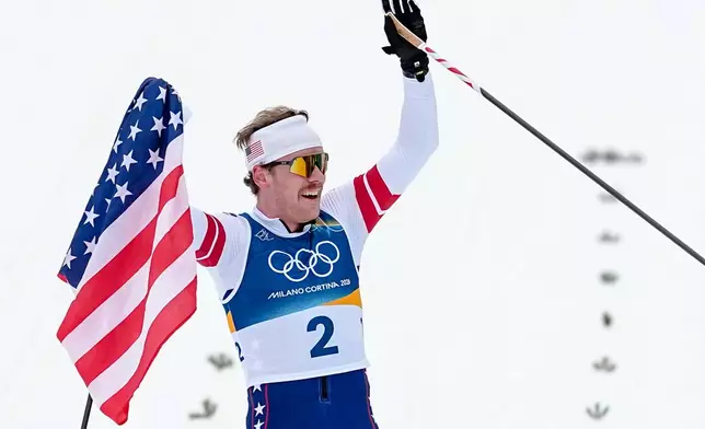 Ben Ogden, of the United States celebrates after winning the silver medal in the cross-country skiing men's sprint classic at the 2026 Winter Olympics, in Tesero, Italy, Tuesday, Feb. 10, 2026. (AP Photo/Matthias Schrader)