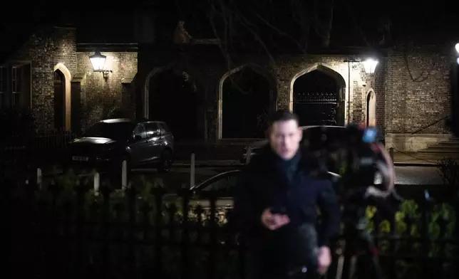 Journalists gather outside the home of Lord Peter Mandelson following his arrest on suspicion of misconduct in public office, in London, Tuesday, Feb. 24, 2026. (James Manning/PA via AP)