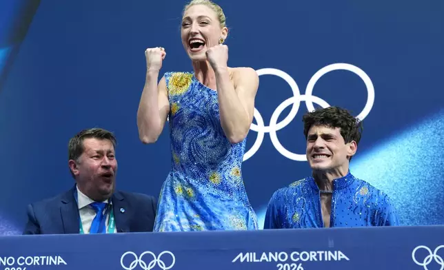 Piper Gilles, center, and Paul Poirier, right, of Canada react to their scores after competing during the ice dancing free skate in figure skating at the 2026 Winter Olympics, in Milan, Italy, Wednesday, Feb. 11, 2026. (AP Photo/Stephanie Scarbrough)