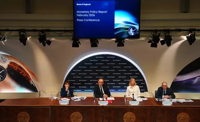 Governor of the Bank of England, Andrew Bailey, 2nd left, flanked by Clare Lombardelli, from left, Katie Martin, and Dave Ramsden talks during a Bank of England Monetary Policy Report press conference in London, Thursday, Feb. 5, 2026. (Carl Court/Pool Photo via AP)