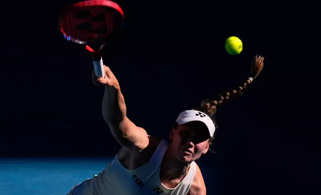 Elena Rybakina of Kazakhstan serves to Elise Mertens of Belgium during their fourth round match at the Australian Open tennis championship in Melbourne, Australia, Monday, Jan. 26, 2026. (AP Photo/Dar Yasin)
