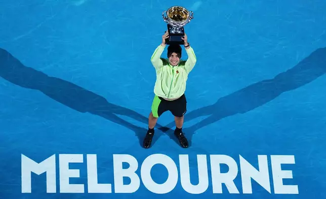 Carlos Alcaraz of Spain holds the Norman Brookes Challenge Cup after defeating Novak Djokovic of Serbia in the men's singles final match at the Australian Open tennis championship in Melbourne, Australia, Sunday, Feb. 1, 2026. (AP Photo/Dar Yasin)