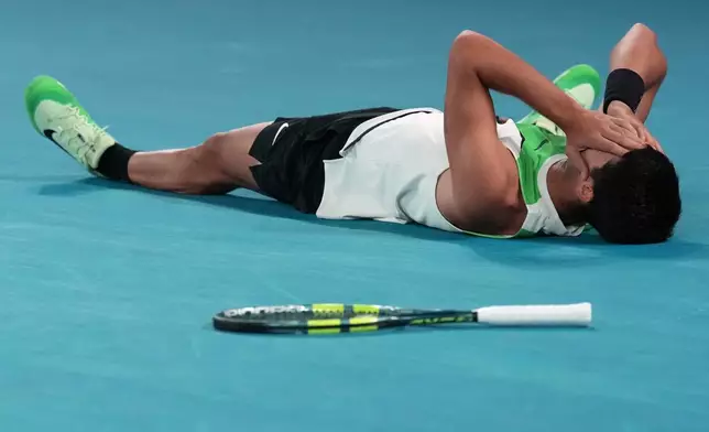 Carlos Alcaraz of Spain celebrates after defeating Novak Djokovic of Serbia in the men's singles final at the Australian Open tennis championship in Melbourne, Australia, Sunday, Feb. 1, 2026. (AP Photo/Dita Alangkara)