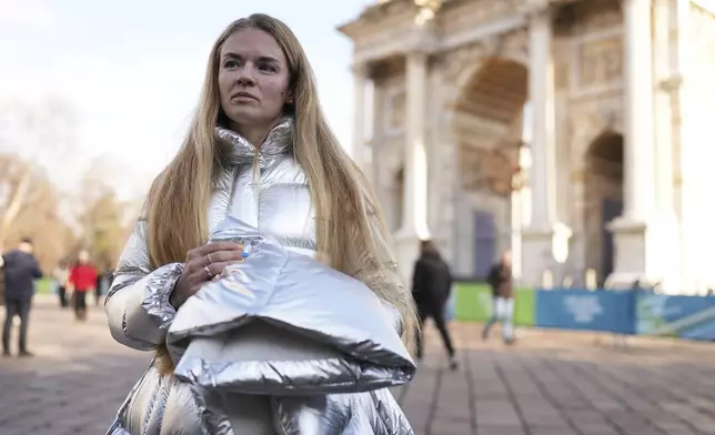 Anastasia Kucherova stands near the Arco della Pace during the 2026 Winter Olympics, in Milan, Italy, Monday, Feb. 16, 2026. (AP Photo/Andrea Rosa)
