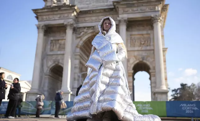 Anastasia Kucherova stands near the Arco della Pace during the 2026 Winter Olympics, in Milan, Italy, Monday, Feb. 16, 2026. (AP Photo/Andrea Rosa)