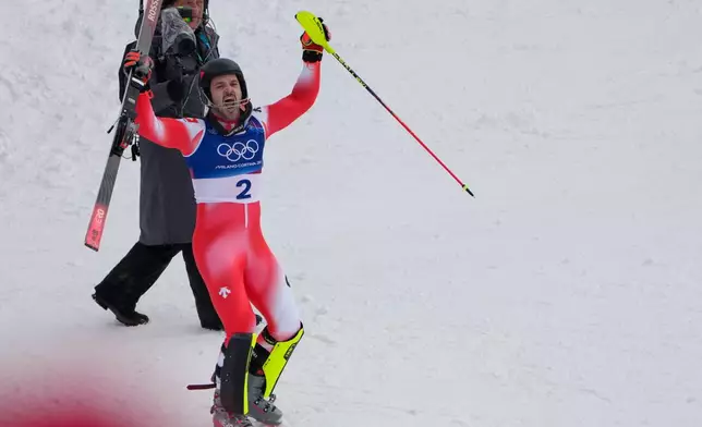 Switzerland's Loic Meillard celebrates winning an alpine ski, men's slalom race, at the 2026 Winter Olympics, in Bormio, Italy, Monday, Feb. 16, 2026. (AP Photo/John Locher)