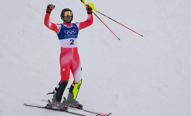 Switzerland's Loic Meillard celebrates winning an alpine ski, men's slalom race, at the 2026 Winter Olympics, in Bormio, Italy, Monday, Feb. 16, 2026. (AP Photo/John Locher)