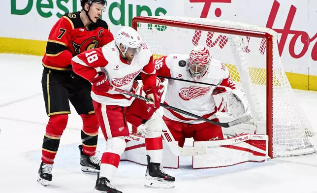Detroit Red Wings' goaltender John Gibson (36) makes a save while under pressure from Ottawa Senators' Brady Tkachuk (7) during the third period of an NHL hockey game, in Ottawa, Ontario, Thursday, Feb. 26, 2026. (Spencer Colby/The Canadian Press via AP)
