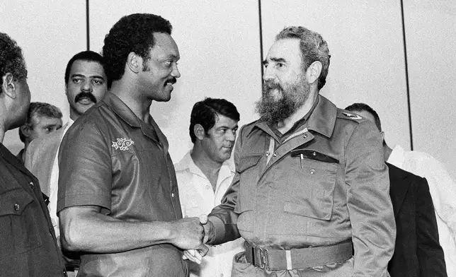 FILE - Democratic Presidential candidate Rev. Jesse Jackson and Cuban President Fidel Castro shake hands following a post-midnight news conference in Havana, Cuba, where the two leaders outlined a plan for improving relations between the U.S. and Cuba, June 7, 1984. (AP Photo/J. Scott Applewhite, File)