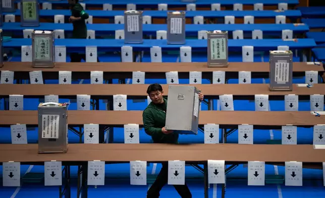 Staff prepare to count the votes for the lower house election in Tokyo, Sunday, Feb. 8, 2026. (AP Photo/Louise Delmotte)