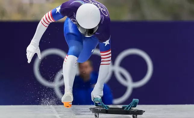 United State's Daniel Barefoot starts for a men's skeleton run at the 2026 Winter Olympics, in Cortina d'Ampezzo, Italy, Thursday, Feb. 12, 2026. (AP Photo/Aijaz Rahi)