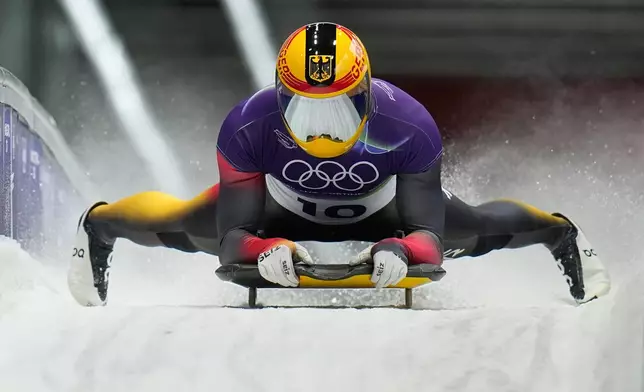 Germany's Axel Jungk arrives at the finish during a men's skeleton run at the 2026 Winter Olympics, in Cortina d'Ampezzo, Italy, Thursday, Feb. 12, 2026. (AP Photo/Alessandra Tarantino)