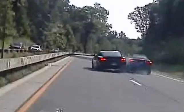 In an image taken from Connecticut State Police police dashcam video, Vince McMahon's car, center left, collides with another car after on July 24, 2025, in Westport, Conn. (Connecticut State Police via AP)