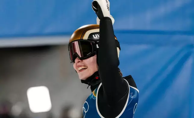 Anna Odine Stroem, of Norway, celebrates after winning the gold medal in the ski jumping women's normal hill individual, at the 2026 Winter Olympics, in Predazzo, Italy, Saturday, Feb. 7, 2026. (AP Photo/Evgeniy Maloletka)