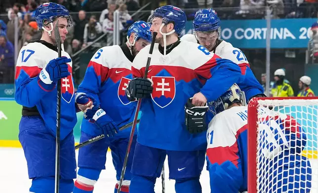 Slovakia players are dejected at the end of a men's ice hockey bronze medal game between Slovakia and Finland at the 2026 Winter Olympics, in Milan, Italy, Saturday, Feb. 21, 2026. (AP Photo/Hassan Ammar)