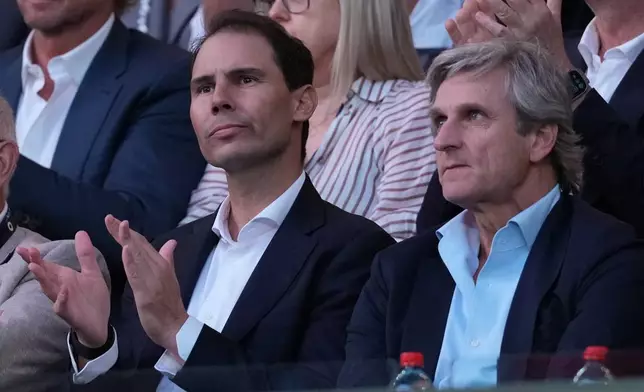 Rafael Nadal, left, and his agent Carlos Costa watch the men's single final between Carlos Alcaraz of Spain and Novak Djokovic of Serbia at the Australian Open tennis championship in Melbourne, Australia, Sunday, Feb. 1, 2026. (AP Photo/Dita Alangkara)