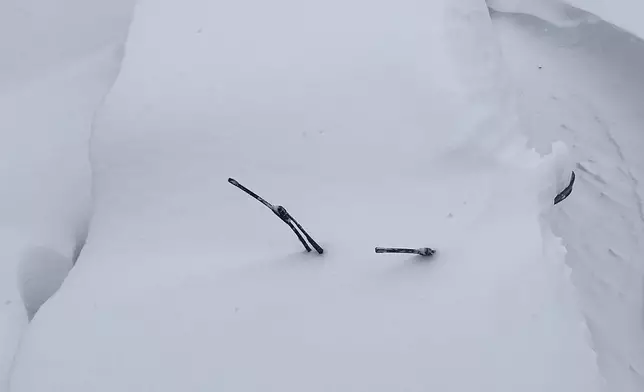FILE - Vehicles are covered in and surrounded by snow after an overnight snowstorm, Feb. 23, 2026, in Fort Lee, N.J. (AP Photo/Pablo Salinas, File)